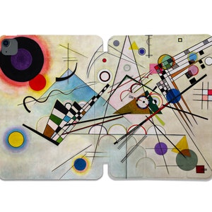 Puede incluir: Impresión de arte abstracto con formas geométricas y líneas en varios colores, incluyendo negro, blanco, rojo, amarillo, azul y verde. La impresión está sobre un fondo blanco.