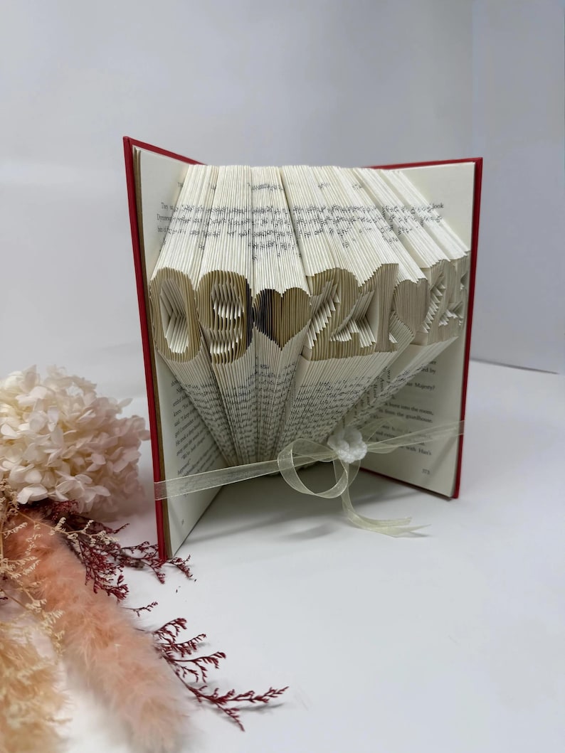 Side view of personalized folded book art featuring a custom date, handmade paper anniversary keepsake.