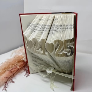 Side view of personalized folded book art featuring a custom date, handmade paper anniversary keepsake.