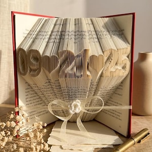 lifestyle image of a folded book with a date design. home decor