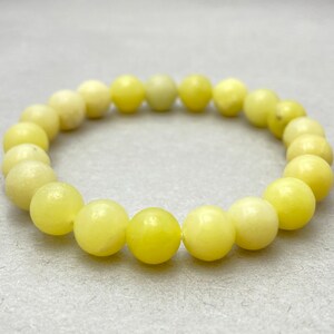 May include: A yellow jade beaded bracelet with round beads.