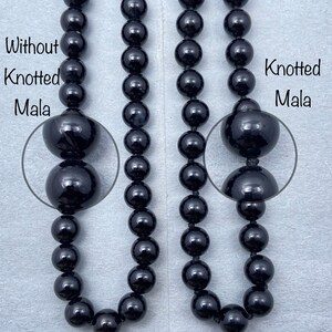 May include: Two black beaded necklaces, one with knots between each bead and one without knots. The necklace with knots is labeled "Knotted Mala" and the necklace without knots is labeled "Without Knotted Mala".
