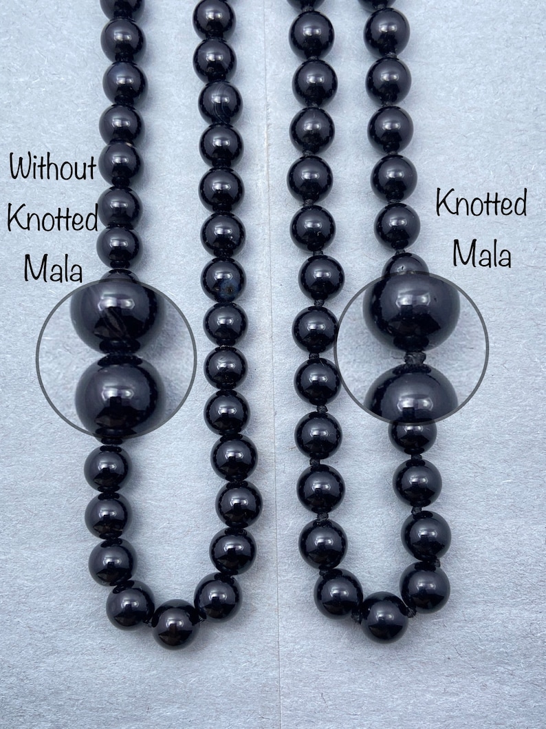 May include: Two black beaded necklaces, one with knots between each bead and one without knots. The necklace with knots is labeled "Knotted Mala" and the necklace without knots is labeled "Without Knotted Mala".