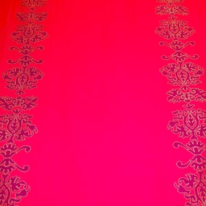 May include: A bright pink background with a vertical border of gold and purple floral designs on each side.