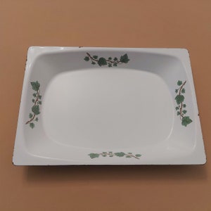 May include: White enamel baking dish with a black rim and green ivy leaf design.