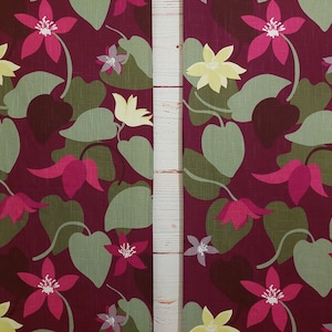 May include: A fabric with a repeating pattern of pink, yellow, and green flowers on a burgundy background.