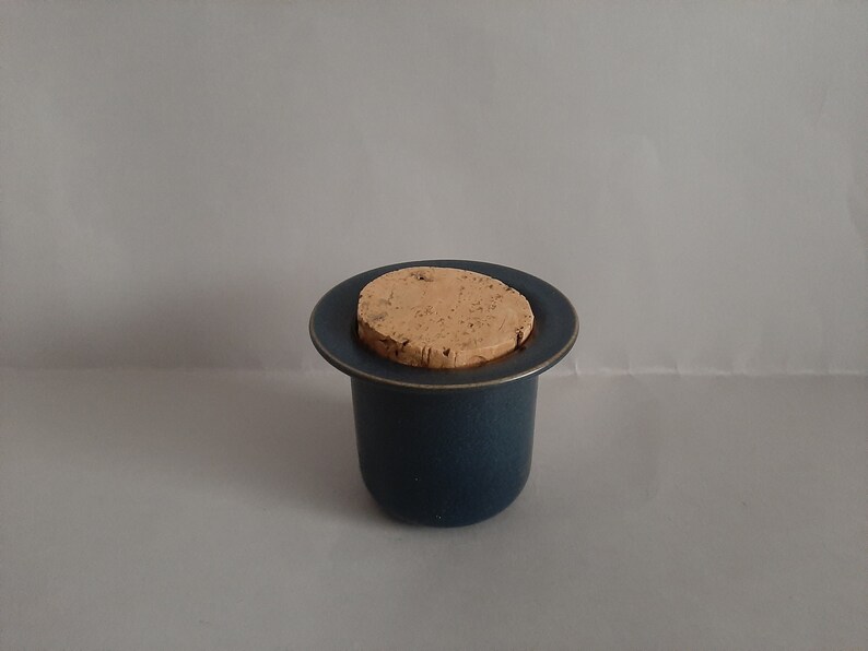 May include: A blue ceramic jar with a cork lid. The jar has a speckled texture.