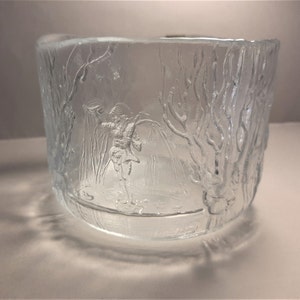 May include: A clear glass bowl with an etched design of a person ice skating in a winter scene.
