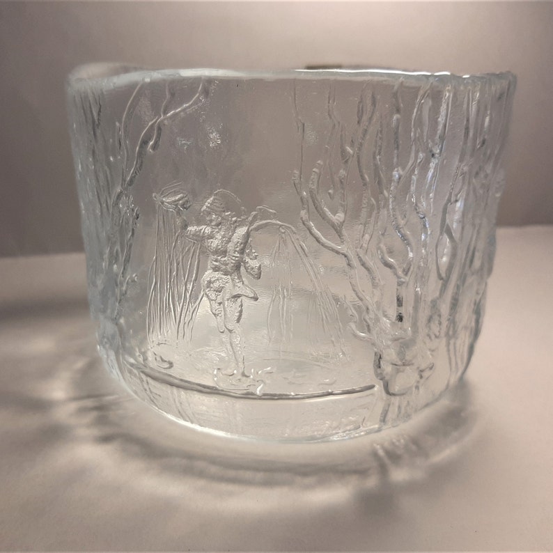 May include: A clear glass bowl with an etched design of a person ice skating in a winter scene.