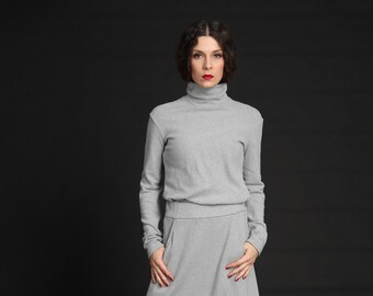 Adherent Knit Sweater with Extended Sleeves and Raised Neck