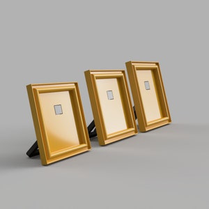 May include: Three gold picture frames with black stands, arranged in a row from left to right.