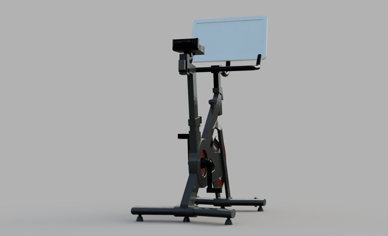 Puede incluir: Bicicleta de ejercicio est&aacute;tica negra con un soporte para tableta blanco. La bicicleta tiene un sill&iacute;n y un manillar negros, y una rueda roja y negra.