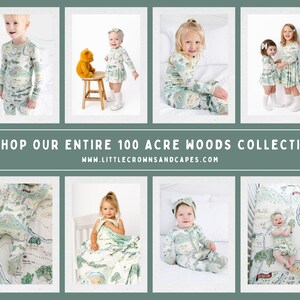 May include: A collection of children's clothing and bedding featuring a woodland map print. The print includes trees, a river, and a road. The clothing includes pajamas, a dress, and a blanket. The bedding includes a fitted sheet and a crib sheet. The text on the image reads "Shop our entire 100 Acre Woods Collection www.littlecrownsandcapes.com".