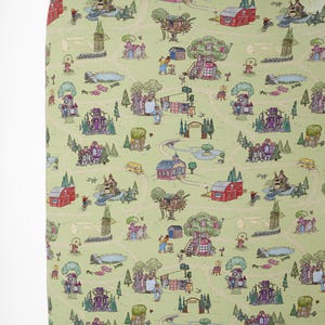 May include: A light green fitted cot sheet with a whimsical map design. The map features houses, trees, roads, and people. The houses are red, purple, and pink. The roads are tan, and the trees are green.