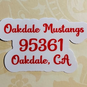 May include: White sticker with red text that reads "Oakdale Mustangs 95361 Oakdale, CA".