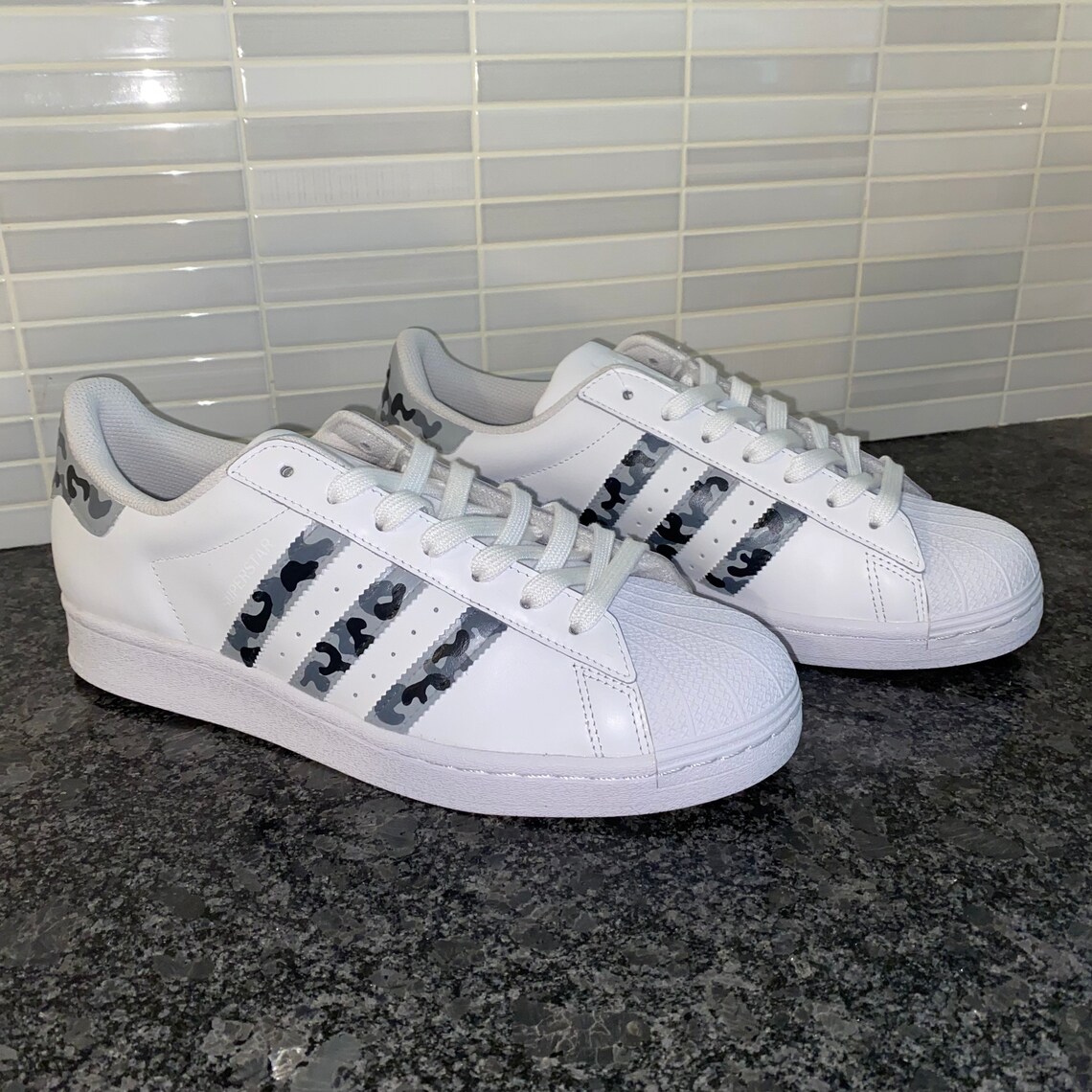 grey superstars with white stripes