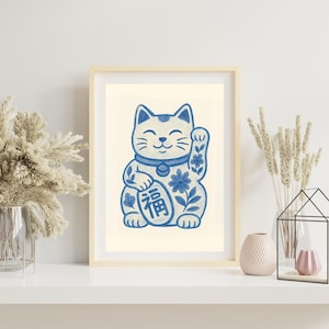 May include: A blue and white ceramic Maneki-Neko, or lucky cat, with a raised paw, floral details, and the Chinese character for "fortune" on its chest.