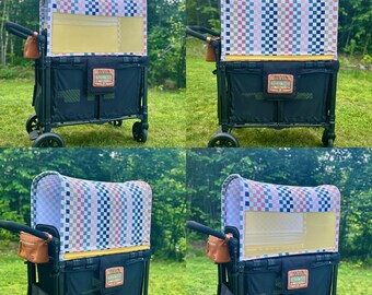Puede incluir: Un carrito utilitario plegable negro con una capota de patrón de cuadros multicolor en rosa, azul y beige. El carrito incluye un cuerpo de tela negra, un parche de aspecto de cuero beige en la parte delantera y una pequeña bolsa de almacenamiento marrón.
