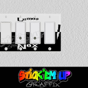 May include: A white light switch plate with four light switches. The plate has a black and white design with the words "Lumos" and "Nox" in black text. The design also includes a lightning bolt graphic.