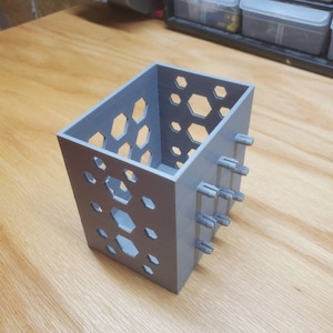 Pegboard box with hexagon cutouts