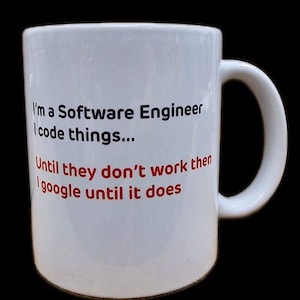 May include: White ceramic mug with a black and red design. The text on the mug reads "I'm a Software Engineer I code things... Until they don't work then I google until it does."
