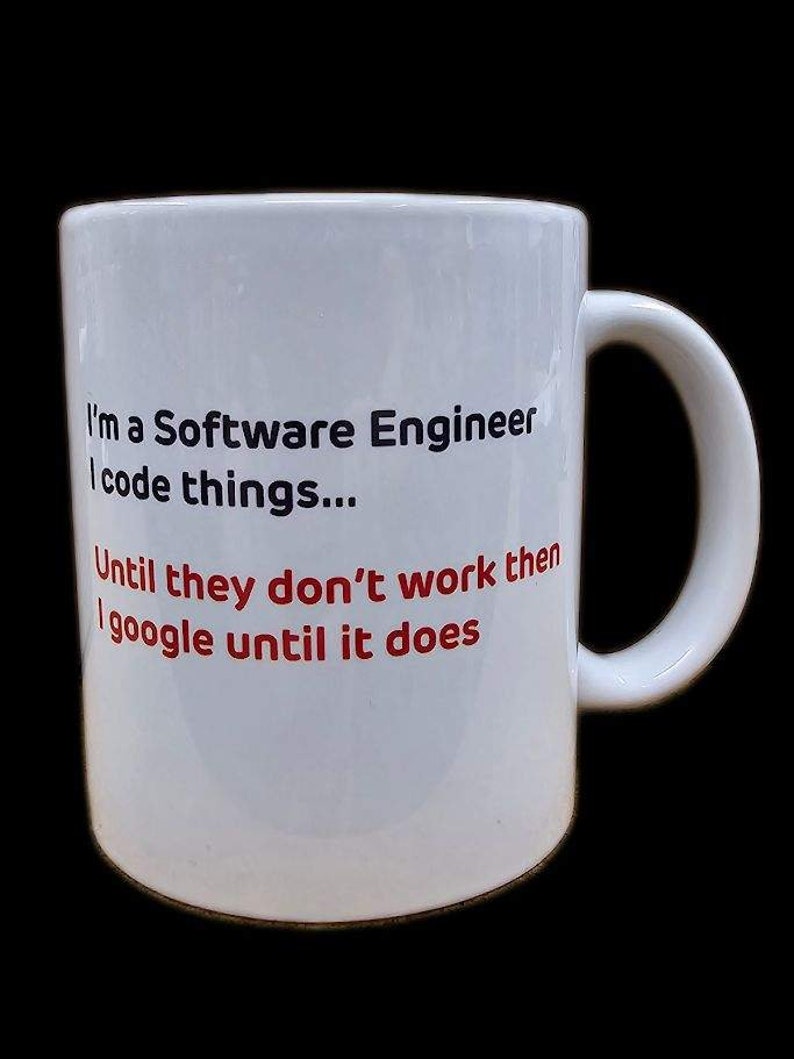 May include: White ceramic mug with a black and red design. The text on the mug reads "I'm a Software Engineer I code things... Until they don't work then I google until it does."