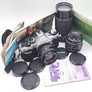 Canon AE-1 PROGRAM 35 mm Filmkamera mit Canon LD 50 mm f/1.8, Star-D 28 mm f2.8, Five Star 75-200 mm f/4.5 Objektive +++ Bonus+++