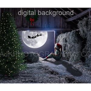May include: A child dressed as an elf sits in a barn, looking out of a window at a full moon. Santa's sleigh is flying in the distance, with reindeer pulling the sleigh. A Christmas tree is in the foreground, and hay bales are in the background.