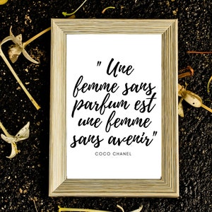 May include: A framed print with a white background and black text that reads "Une femme sans parfum est une femme sans avenir" by Coco Chanel.