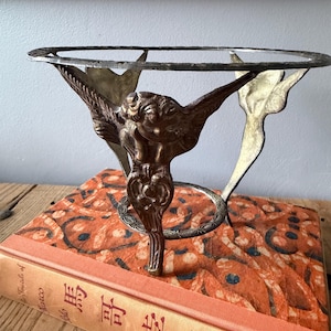 May include: A set of three ceramic canisters with lids. The canisters are white with a textured surface and feature a black geometric pattern. The lids are black. The canisters are likely for kitchen storage.