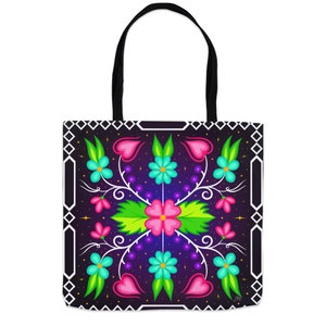 May include: A black tote bag featuring a colourful floral design. The flowers are pink, blue, green and yellow. The background is a dark purple with white stars. The bag has black handles.