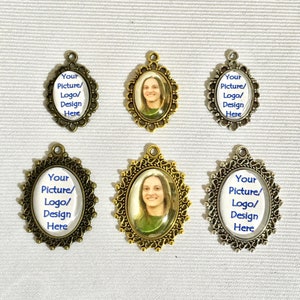 May include: Six oval-shaped metal charms with ornate frames. Each charm has a clear glass insert with a space for a picture, logo, or design. The charms are in three different finishes: gold, silver, and bronze.
