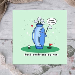 May include: A green card with a cartoon golf bag holding golf clubs and a golf ball. The golf bag has a happy face and the text "Happy Birthday" in a speech bubble. The text "best boyfriend by par" is below the cartoon.
