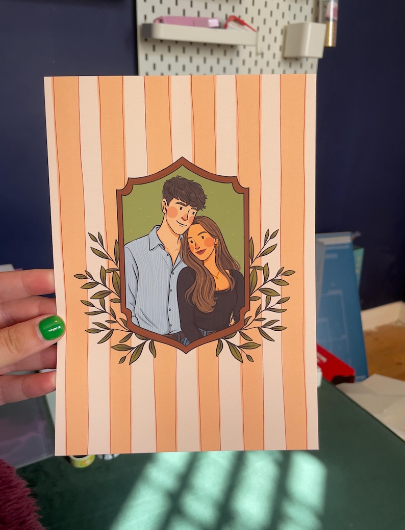 May include: A rectangular art print featuring a vertical peach and white striped background. In the center, a brown ornate frame encloses a digital illustration of two people standing together, surrounded by green leafy branches on both sides.