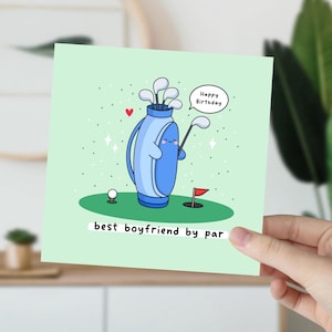 May include: A green card with a cartoon illustration of a golf bag holding a golf club. The golf bag has a happy face and a speech bubble that says "Happy Birthday". The card says "best boyfriend by par".