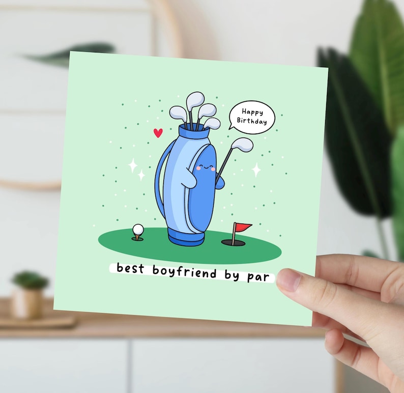 May include: A green card with a cartoon illustration of a golf bag holding a golf club. The golf bag has a happy face and a speech bubble that says "Happy Birthday". The card says "best boyfriend by par".