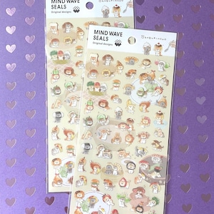 May include: Two sheets of Mind Wave Seals stickers featuring Okaburineko original designs. Each sheet contains numerous small, colorful illustrations of cats interacting with various food items, including sushi, bread, and vegetables, on a light background.