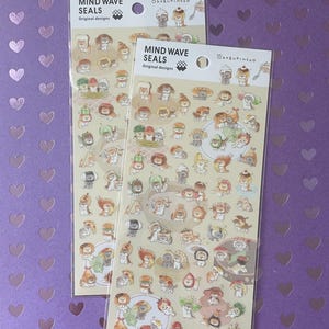 May include: Two sticker sheets featuring adorable cartoon animals in various costumes and poses. The stickers are on a light beige background with the text "MIND WAVE SEALS Original Designs". The background is a purple surface with heart shapes.