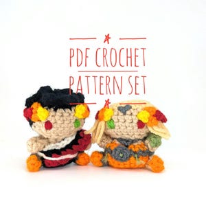 May include: Two crocheted dolls with floral headbands and colourful outfits. One doll has black hair and a red and black outfit, the other has blonde hair and an orange and grey outfit. The text "PDF CROCHET PATTERN SET" is above the dolls.