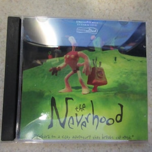 May include: A CD case for the video game "The Neverhood", featuring a claymation character on a green background. The text "DreamWorks Interactive" and "The Neverhood" are visible on the case.