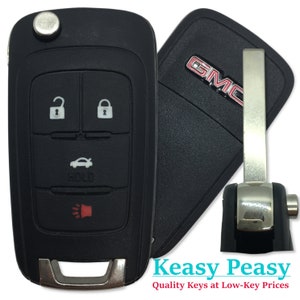 May include: Black car key fob with four buttons: lock, unlock, trunk, and panic. The key fob has a silver trim and a GMC logo on the side. The key fob also has a silver key blade.