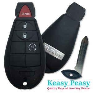 May include: Black car key fob with a silver RAM logo, four buttons, and a red panic button. The key fob also includes a black key blade.