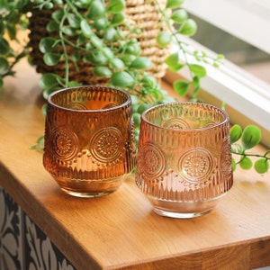 Set of 2 richly coloured orange and pink glass lanterns, each with an embossed floral design
