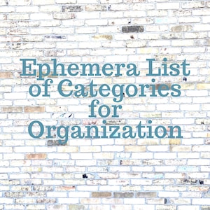 May include: A white brick wall with the text "Ephemera List of Categories for Organization" in blue.