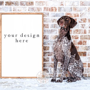 May include: A white framed sign with the text "your design here" on a brick wall background. A brown and white German Shorthaired Pointer dog is sitting in front of the sign.