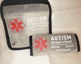 Könnte beinhalten: Zwei graue Stoff-Sicherheitsgurtschoner für Autos mit einem roten medizinischen Symbol und dem Text "AUTISM Mein Name ist Vincent Nicht sprechend Kann Widerstand leisten Kann nicht antworten".