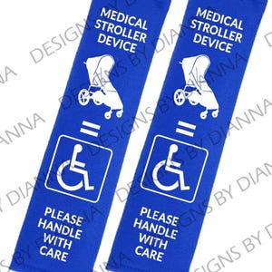 May include: Two blue stroller straps with white text and a wheelchair symbol. The text reads "Medical stroller device" and "Please handle with care".