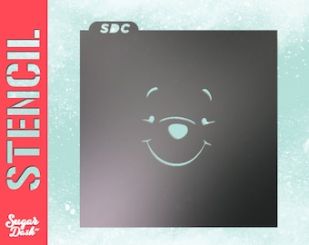 May include: A black stencil with the text "SDC" in the top left corner. The stencil features a simple outline of Winnie the Pooh's face with a smile.