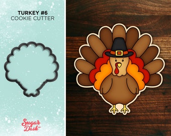 May include: A cookie cutter in the shape of a Thanksgiving turkey. The turkey is brown with a red wattle and a yellow beak. It is wearing a black pilgrim hat with a gold buckle. The turkey has a brown and orange fan of feathers.
