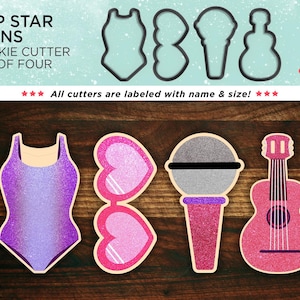 May include: Set of four cookie cutters shaped like a swimsuit, sunglasses, microphone, and guitar. The cutters are pink, purple, and silver with glitter.